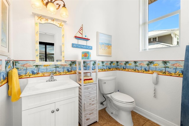 bathroom featuring vanity, tile patterned floors, and toilet