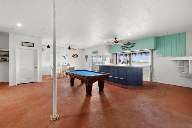 recreation room featuring ceiling fan, pool table, concrete floors, and a textured ceiling