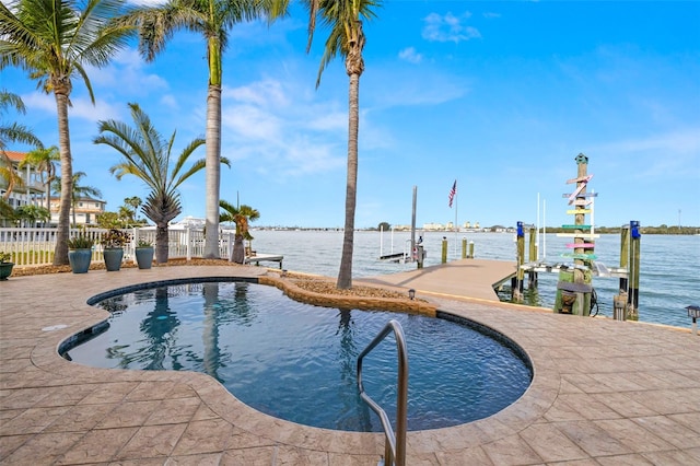 view of pool with a boat dock and a water view