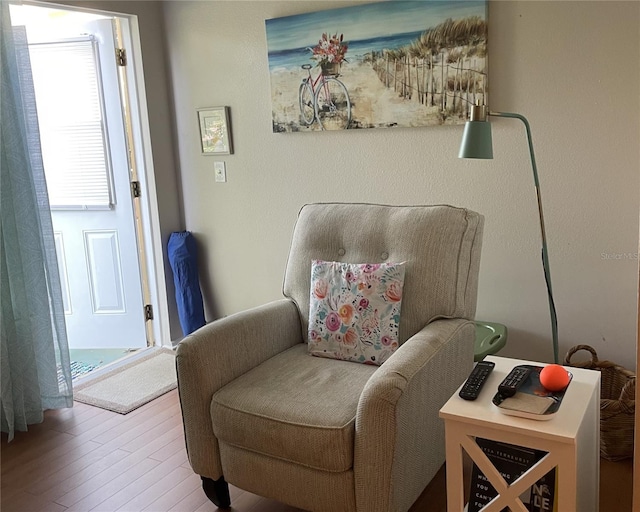 sitting room with hardwood / wood-style flooring