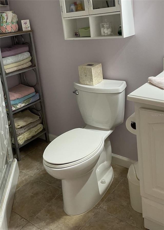 bathroom featuring vanity, tile patterned floors, and toilet