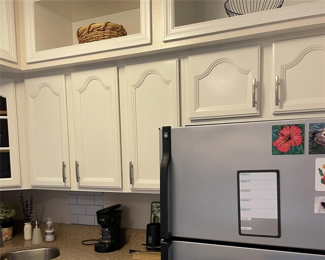 interior space featuring stainless steel refrigerator and sink