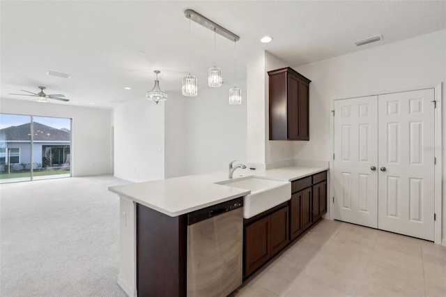 kitchen with sink, dark brown cabinets, decorative light fixtures, stainless steel dishwasher, and kitchen peninsula