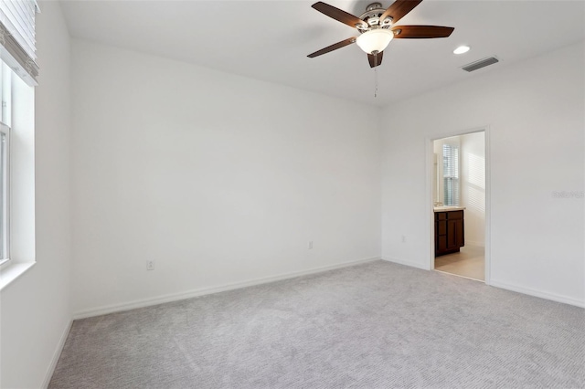 spare room with light carpet and ceiling fan