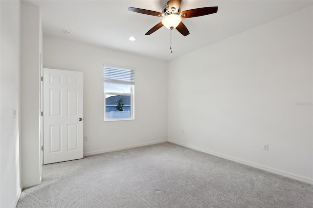 carpeted empty room featuring ceiling fan