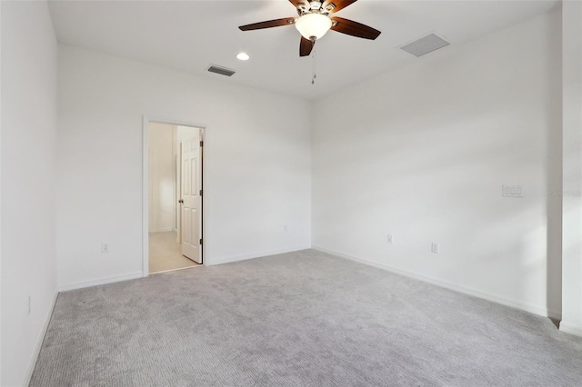 spare room with light carpet and ceiling fan