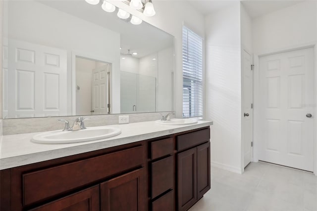 bathroom with tile patterned floors, vanity, and an enclosed shower