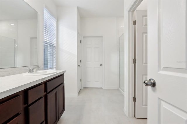 bathroom with vanity and a shower with door