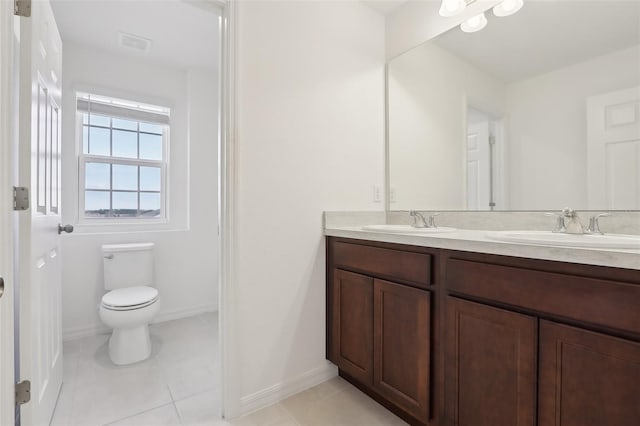 bathroom featuring vanity, tile patterned floors, and toilet