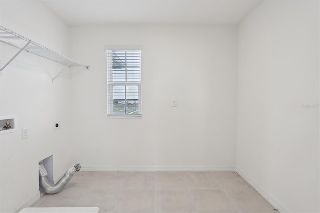 laundry area with washer hookup, electric dryer hookup, and light tile patterned flooring