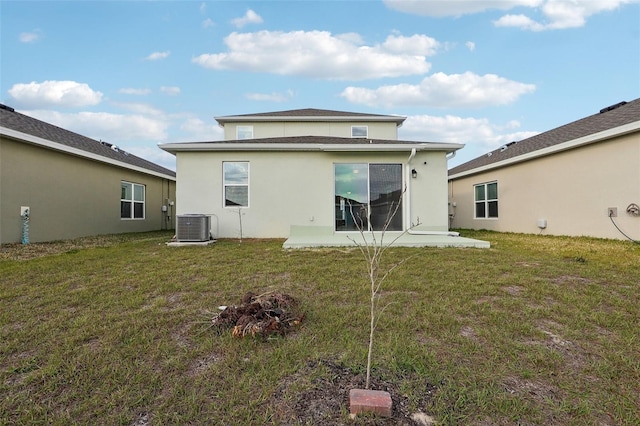 rear view of property featuring central AC unit, a patio, and a lawn