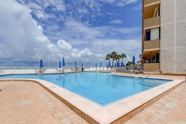 view of swimming pool with a patio