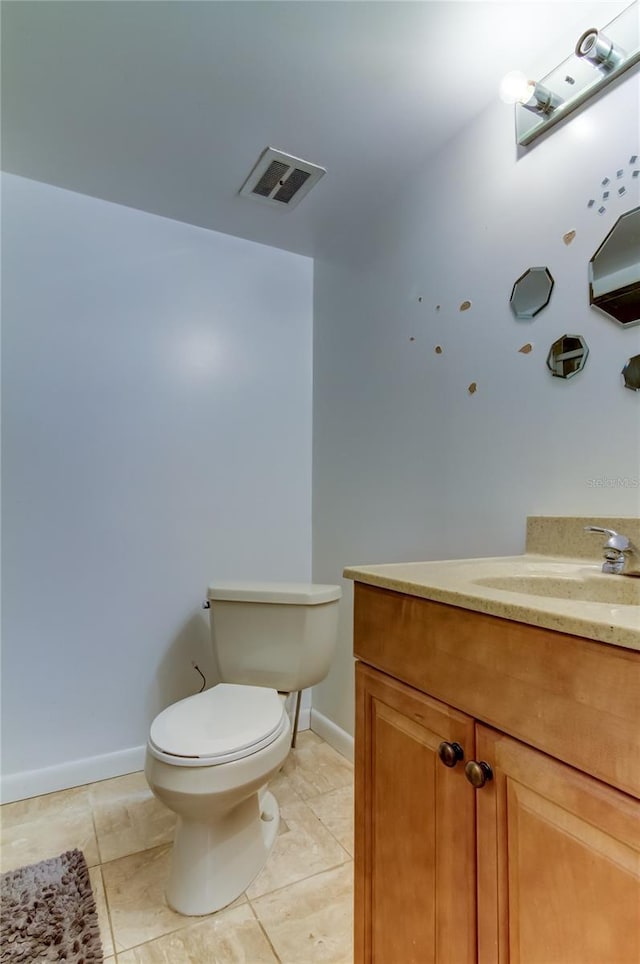 bathroom with vanity, tile patterned flooring, and toilet