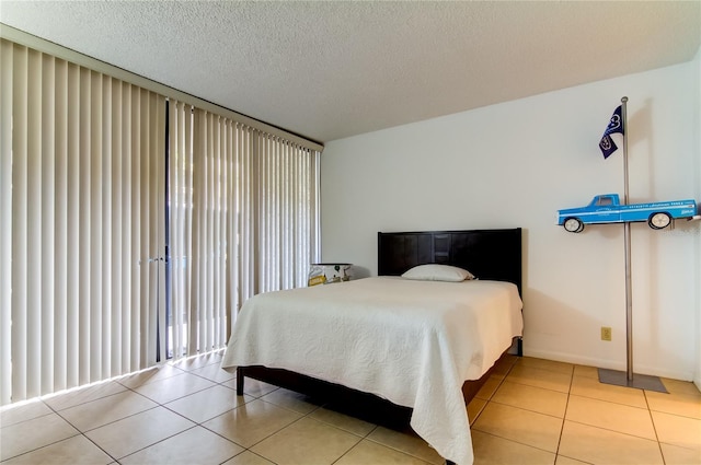 tiled bedroom with a textured ceiling