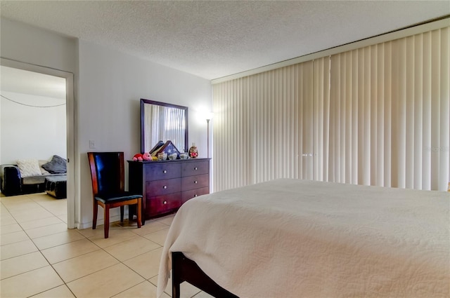 bedroom featuring a textured ceiling and light tile patterned flooring