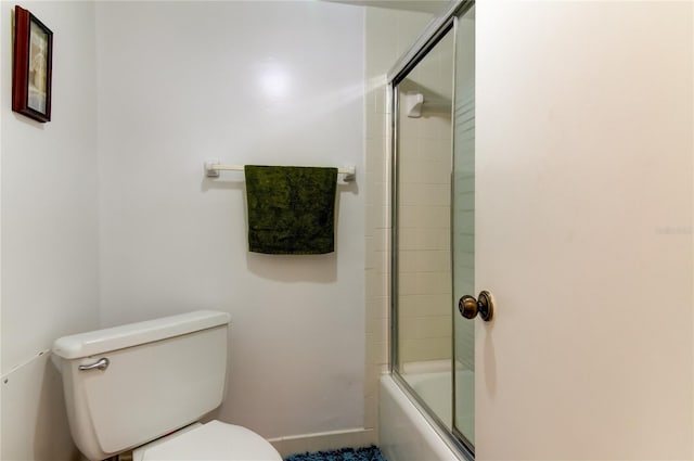 bathroom with shower / bath combination with glass door and toilet