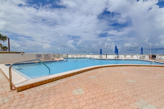 view of swimming pool with a patio area