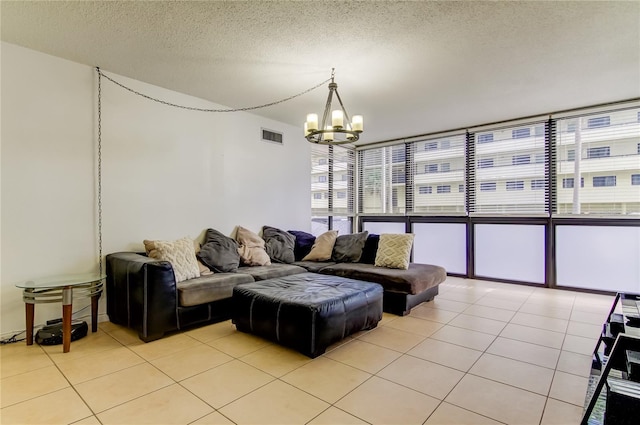 5396 Gulf Blvd Unit 110, St Pete Beach, FL 33706 - living area with a chandelier, light tile patterned flooring, and a textured ceiling