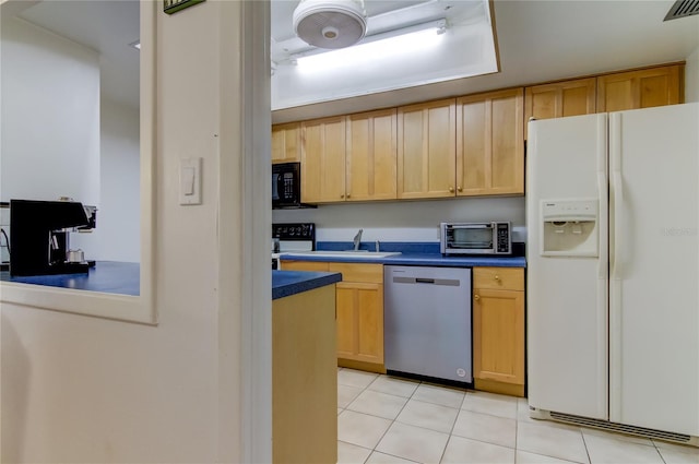 5396 Gulf Blvd Unit 110, St Pete Beach, FL 33706 - kitchen featuring white refrigerator with ice dispenser, stainless steel dishwasher, dark countertops, and black microwave