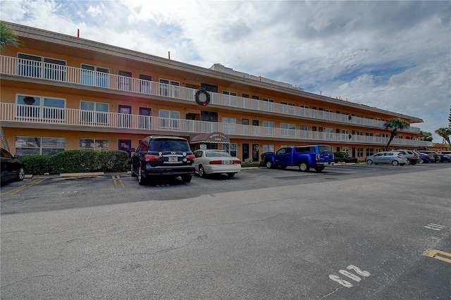 view of building exterior featuring uncovered parking