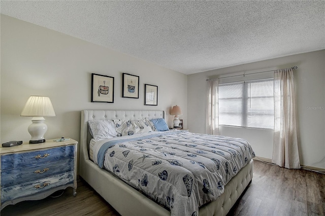 bedroom featuring dark wood-type flooring and a textured ceiling