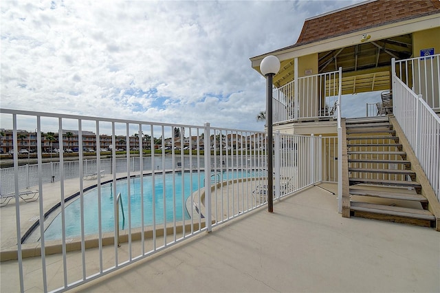 pool featuring fence and a patio