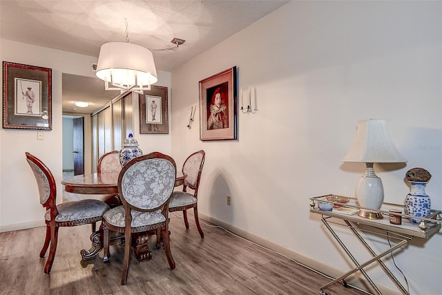 6400 46th Ave N Unit 307, Kenneth City, FL 33709 - dining area featuring wood finished floors and a chandelier