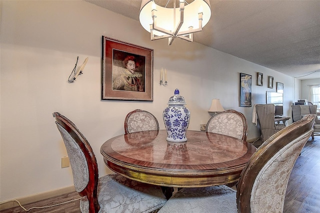 6400 46th Ave N Unit 307, Kenneth City, FL 33709 - dining room with wood finished floors, a chandelier, and a textured ceiling