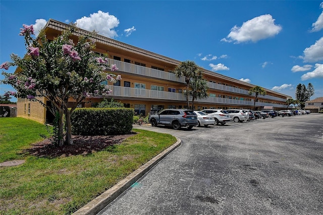 6400 46th Ave N Unit 307, Kenneth City, FL 33709 - view of building exterior with uncovered parking