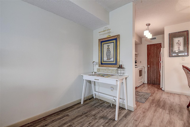 6400 46th Ave N Unit 307, Kenneth City, FL 33709 - hall featuring light wood-type flooring and a textured ceiling