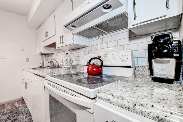 6400 46th Ave N Unit 307, Kenneth City, FL 33709 - kitchen with white appliances, range hood, decorative backsplash, and white cabinets