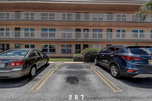 6400 46th Ave N Unit 307, Kenneth City, FL 33709 - view of building exterior with uncovered parking