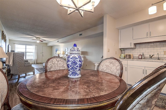 6400 46th Ave N Unit 307, Kenneth City, FL 33709 - dining room with a ceiling fan, a textured ceiling, and wood finished floors