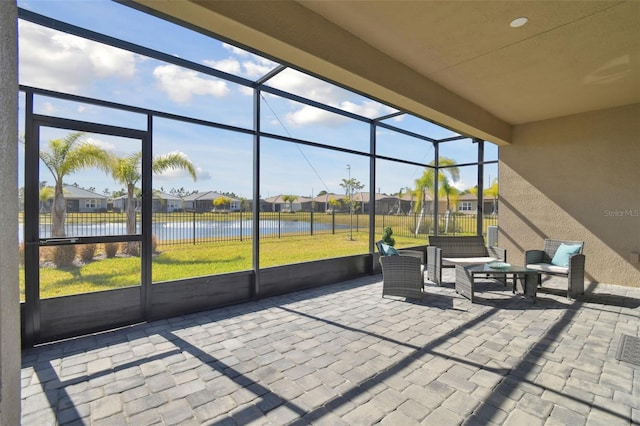 unfurnished sunroom featuring a water view