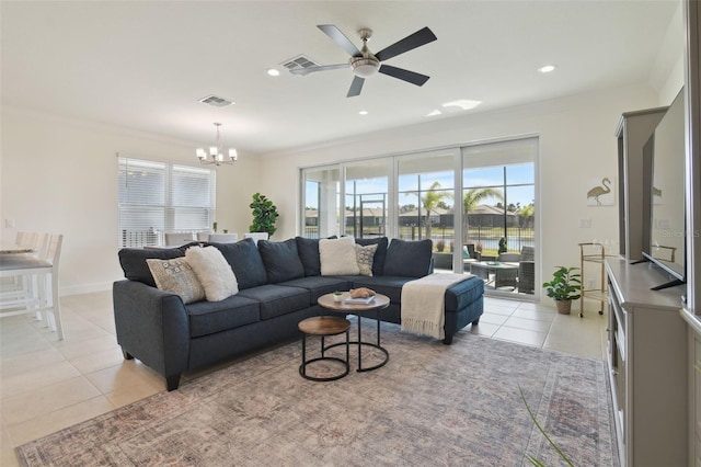 living room featuring crown molding, ceiling fan with notable chandelier, and light tile patterned flooring