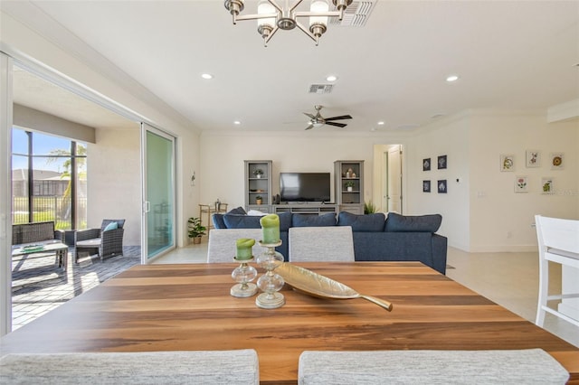 dining room featuring crown molding and ceiling fan with notable chandelier