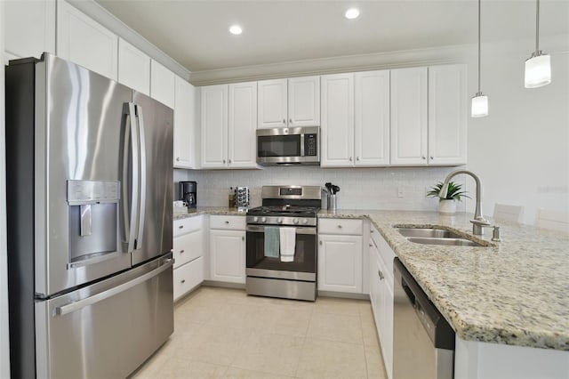 kitchen featuring pendant lighting, sink, backsplash, stainless steel appliances, and white cabinets