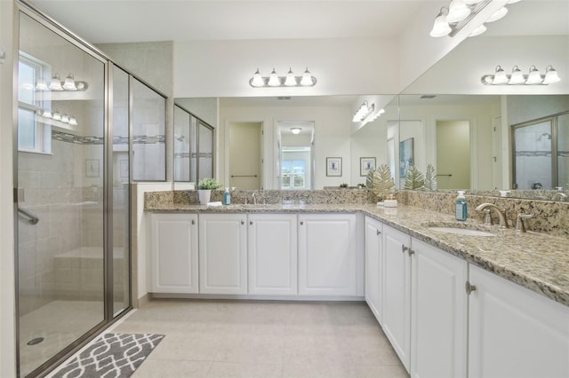 bathroom with vanity, an enclosed shower, and tile patterned flooring