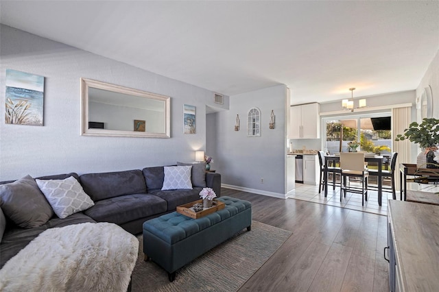 living room featuring light hardwood / wood-style flooring and a chandelier