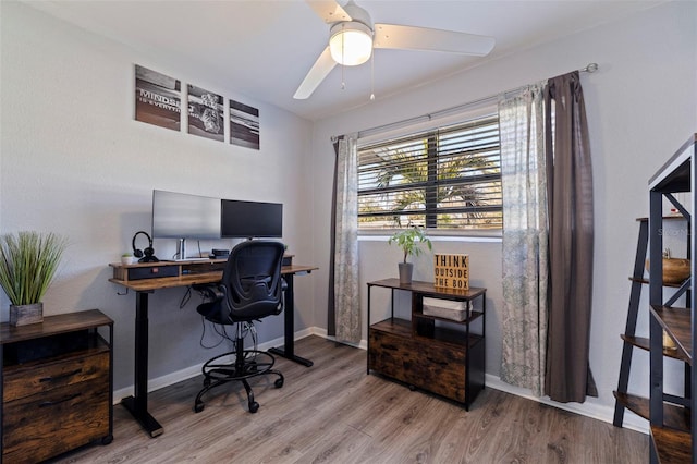 home office featuring wood-type flooring and ceiling fan