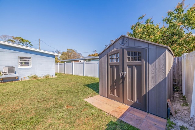 view of yard featuring a shed and cooling unit