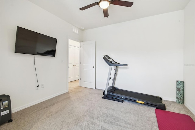 workout room with ceiling fan and light carpet