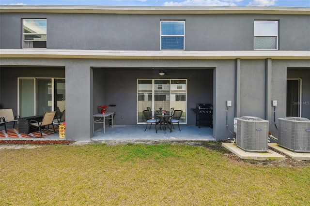 back of house with ceiling fan, a patio area, central air condition unit, and a lawn