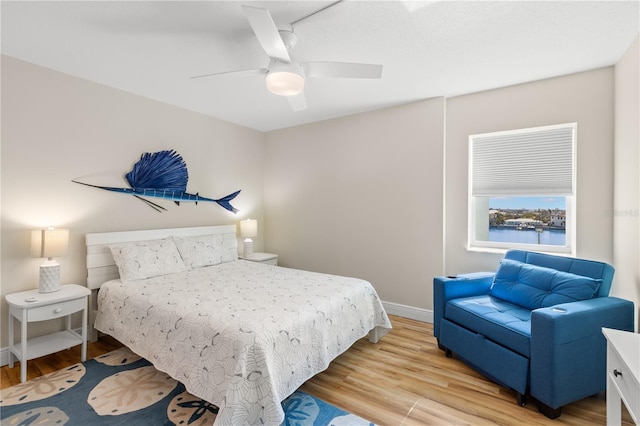 bedroom with ceiling fan and light wood-type flooring