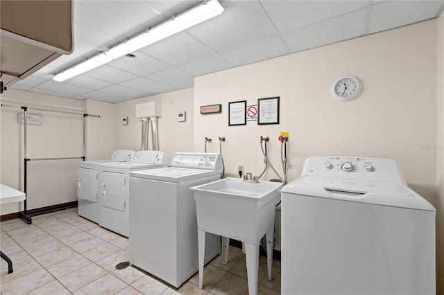 laundry room with light tile patterned flooring and washing machine and dryer