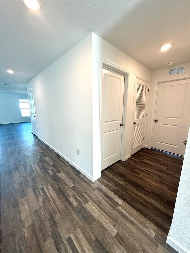 empty room with dark hardwood / wood-style floors