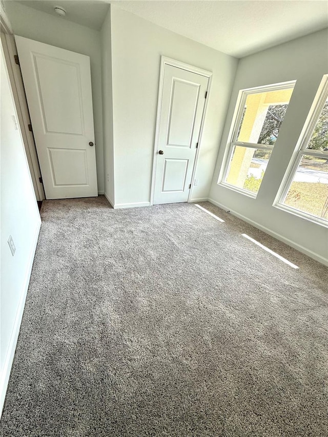 unfurnished bedroom featuring light colored carpet