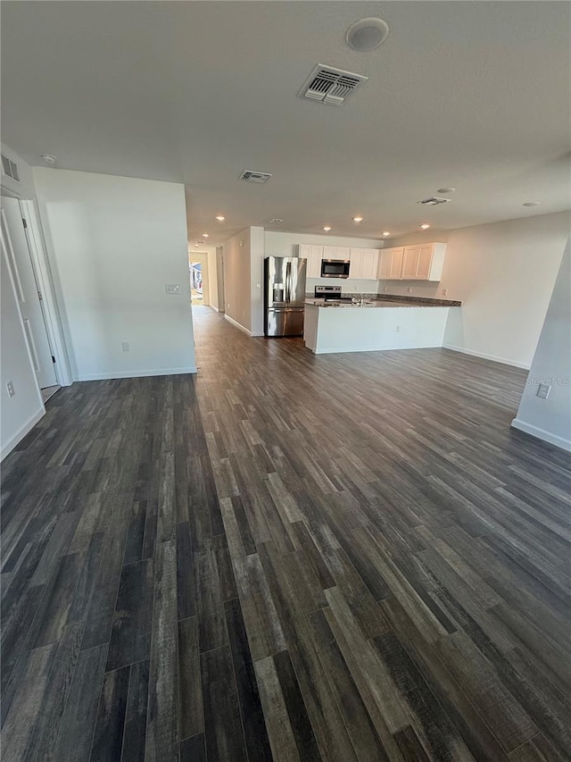 unfurnished living room with dark hardwood / wood-style floors