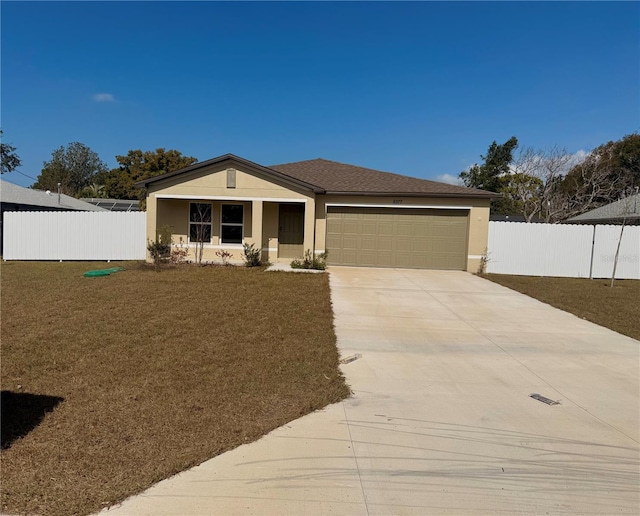 view of front of property featuring a garage and a front yard