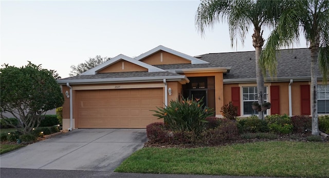 ranch-style home with a garage and a front yard